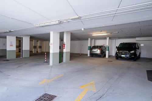 a parking garage with two cars parked in it at Borgo Le Terrazze in Bellagio