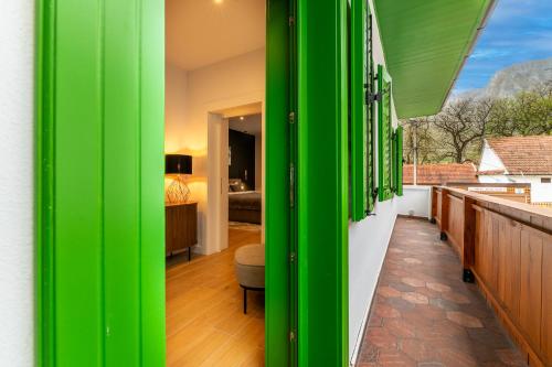 a green wall on a balcony with a bedroom at Pensiunea Casa Weiss in Rimetea