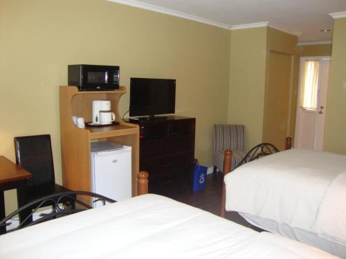 Ένα ή περισσότερα κρεβάτια σε δωμάτιο στο Annapolis Royal Inn & Suites