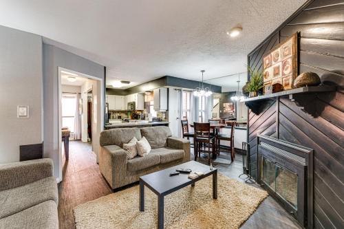 a living room with a couch and a fireplace at 2 Blocks to Angel Fire Resort Family Condo in Angel Fire