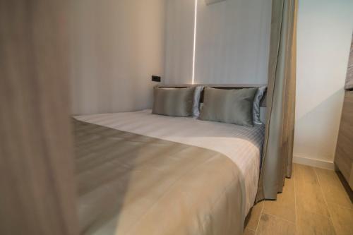 a bed with two pillows in a small room at Vila Luca in Mostar