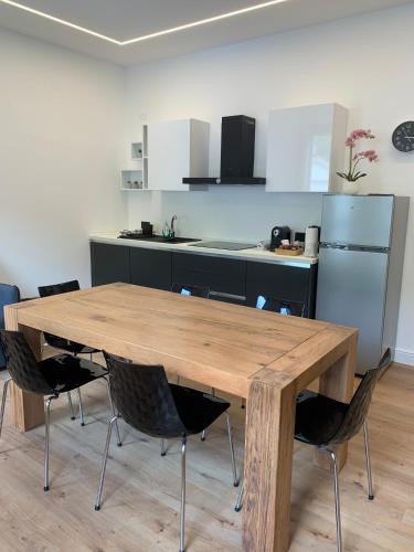 a kitchen with a wooden table and chairs at La casa di Elena in Valdobbiadene