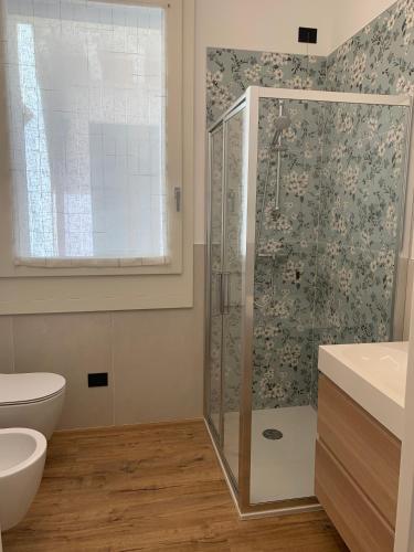 a bathroom with a shower and a toilet and a sink at La casa di Elena in Valdobbiadene