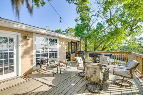 a deck with chairs and tables on a house at Bayfront Haven Group Getaway in Milton! in Milton