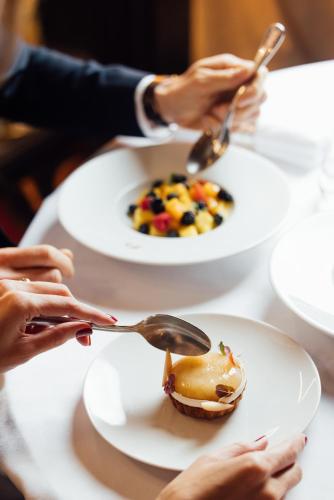 a group of people eating food on a table at Hôtel Barrière Fouquet's Paris in Paris
