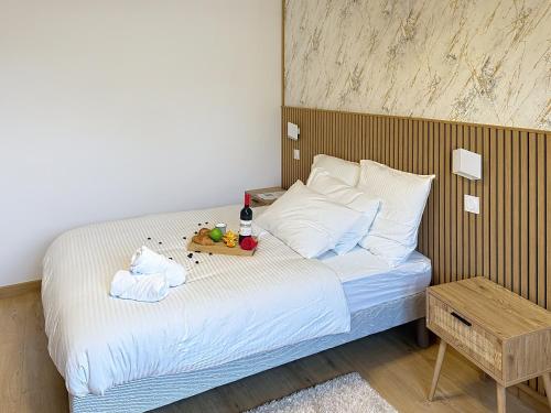 a bedroom with a bed with a tray of food on it at Sky Apartment- Paris - Blanc Mesnil in Le Blanc-Mesnil
