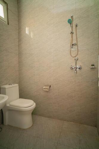a bathroom with a toilet and a shower at Hotel Juju in Pokhara