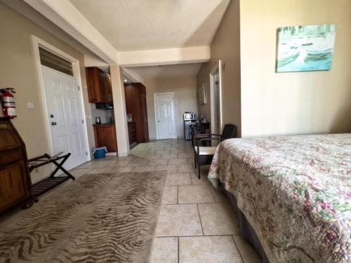 a bedroom with a bed and a living room at Timbos Suites in Goodwill
