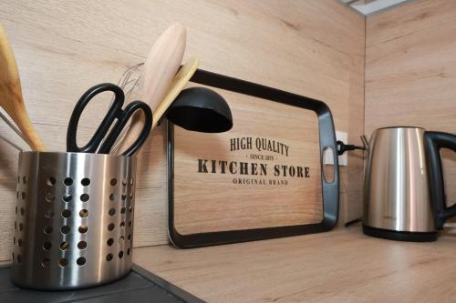 a container of kitchen utensils sitting on a counter at Maison de charme au cœur d Elne in Elne