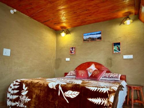 a bedroom with a bed in a room at The Chakras Valley Homestay in Binsar
