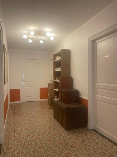 an empty hallway with a room with a door and some boxes at Les volets verts in Saint-Laurent-de-la-Cabrerisse
