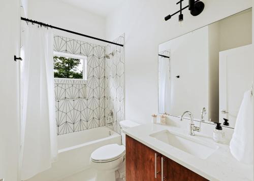 a white bathroom with a tub and a sink and a toilet at Serenity Now 4br Fall Retreat Deck Fireplace in Young Harris