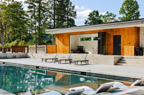 a house with a swimming pool in front of it at Serenity Now 4br Fall Retreat Deck Fireplace in Young Harris