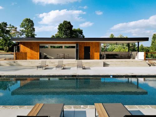 a house with a swimming pool and a patio at Serenity Now 4br Fall Retreat Deck Fireplace in Young Harris