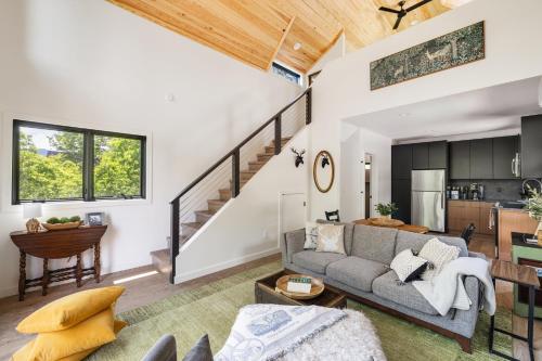 a living room with a couch and a table at Viking Hut Modern Forest Hideaway Fall Dogs in Young Harris