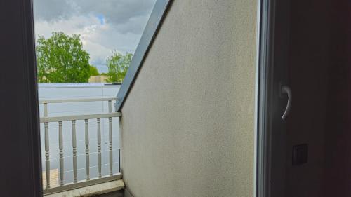a view from a door of a balcony at Best Western Hotel Acadie Paris Nord Villepinte in Tremblay En France