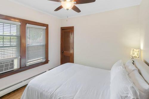 a white bedroom with a bed and a ceiling fan at DT Libertyville Home With Arcade PacMan by Navy Base in Libertyville