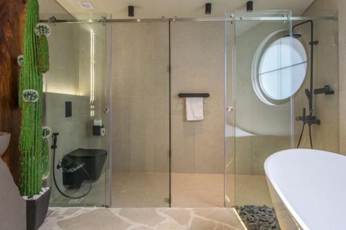 a shower with a glass door in a bathroom at Beit Chams 3 Suites in Batroun in Batroûn