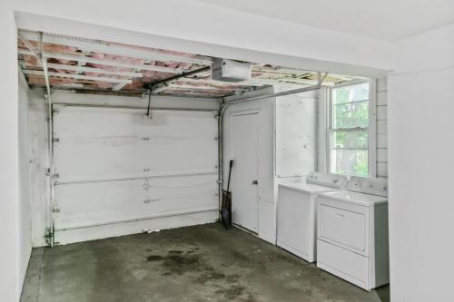 an empty room with white cabinets and a window at Apt with heated garage Libertyville Near Naval Base in Libertyville