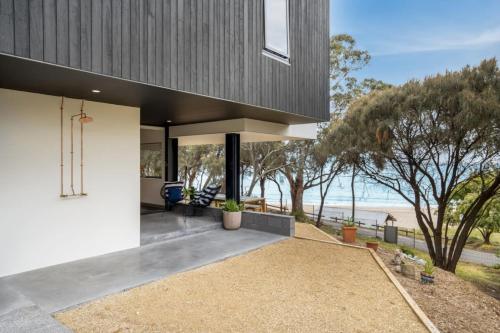 a house with a view of the ocean at Beachfront Studio with Breathtaking Views in Kingston Beach