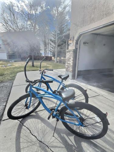 a blue bike parked on a sidewalk next to a garage at Large Modern Driggs Home with Game Room and Jacuzzi! in Driggs