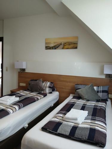 two beds sitting next to each other in a room at Landgasthof zum SEEHOF in Rottweil