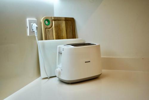 a toaster sitting on a counter next to a refrigerator at Ribera del Marlin - Sotogrande in Sotogrande