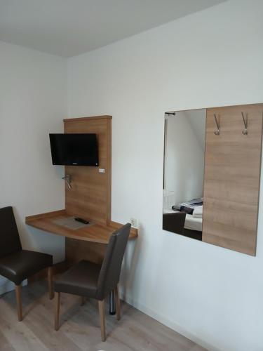 a room with a desk and a mirror and a table at Landgasthof zum SEEHOF in Rottweil