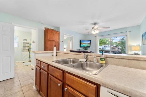a kitchen with a sink and a living room at LOTO BREEZE 2 in Sunrise Beach