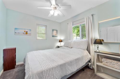 a white bedroom with a bed and a window at LOTO BREEZE 2 in Sunrise Beach