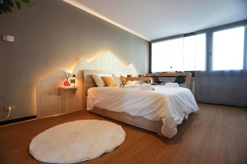 a bedroom with a large bed with a geometric headboard at Sauna Relax in Piancavallo mountain in Piancavallo