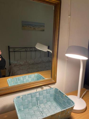 a mirror and a lamp on a table next to a bed at La Villetta in Lacona