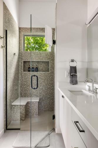 a white bathroom with a shower and a sink at Paradise View 4br Fall Retreat Firepit Dogs in Young Harris