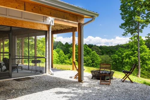 a screened in porch with a view of the woods at Paradise View 4br Fall Retreat Firepit Dogs in Young Harris