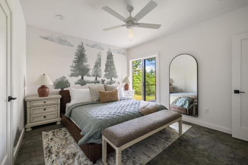 a bedroom with a bed and a mirror at Skips Hideaway 4br Fall Retreat Hot Tub Dog in Young Harris