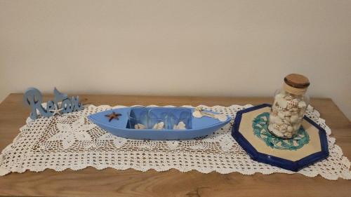 a table with a blue tray and a bottle and a container at Miro' dreams in Alzate Brianza
