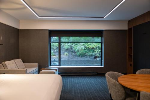 a hotel room with a bed and a window at Hotel Bonaventure Montreal in Montréal