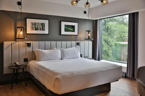 a bedroom with a large bed and a large window at Hotel Bonaventure Montreal in Montréal