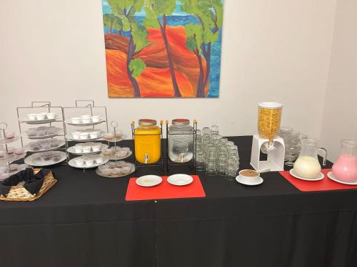 a black table with plates of food and vases at Hotel Lyon by MH in Buenos Aires