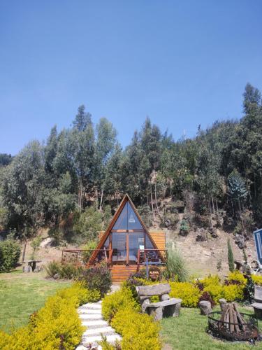 a small cabin in the middle of a garden at Aldea Fuquenense in Fúquene