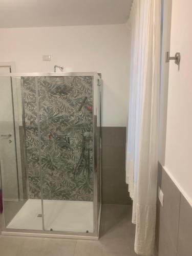 a shower with a glass door in a bathroom at Luciano Home in Gonnesa