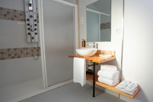 a bathroom with a sink and a shower at O Camiño Fala Hotel in Mazaricos