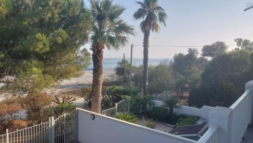 a view of the beach from the balcony of a house at Max in Condofuri