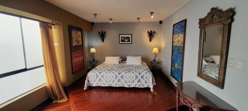 a bedroom with a bed and a large window at Black Shark Apartments in Lima