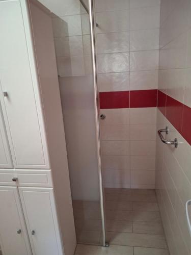 a shower with a glass door in a bathroom at Ker Ode in La Plaine-sur-Mer