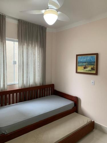 a bedroom with a bed and a window at Apartamento em Bombinhas - 120 metros da praia in Bombinhas