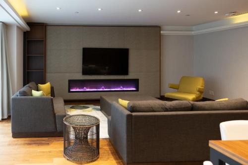 a living room with a couch and a fireplace at Hotel Bonaventure Montreal in Montréal