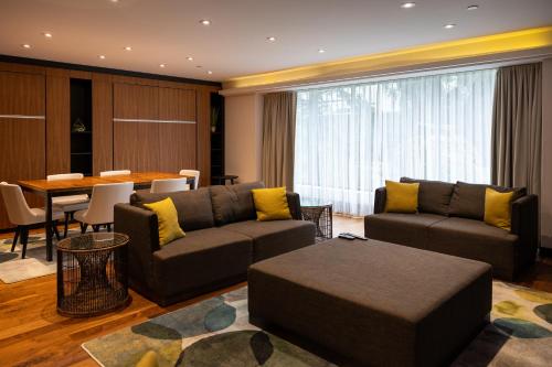 a living room with couches and a table and a dining room at Hotel Bonaventure Montreal in Montréal