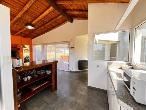 a kitchen with a sink and a counter top at Brisas de Brandsen, Chacras con estilo in Loma Verde