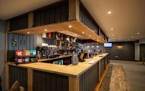 a bar in a restaurant with a counter with alcohol at Sea Breeze Escape in Cubert